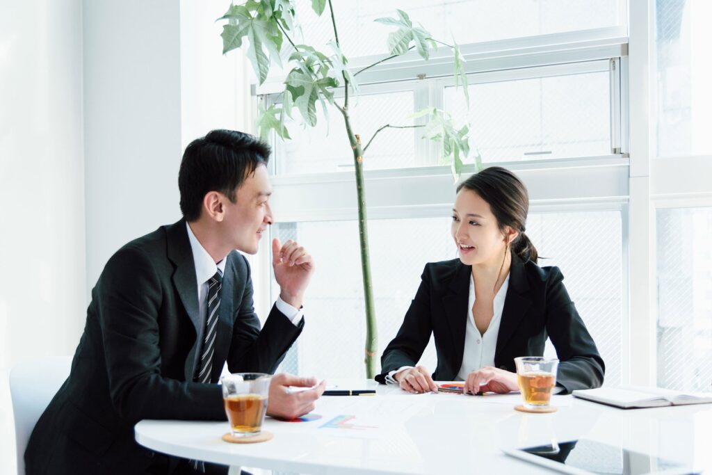 Two colleagues talking at a meeting table